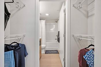 A white bathroom with a toilet, sink, and shower.